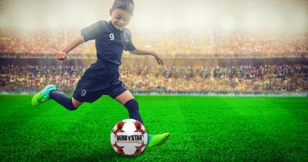 Junge spielt Fußball mit DERBYSTAR Bundesliga Ball Replica